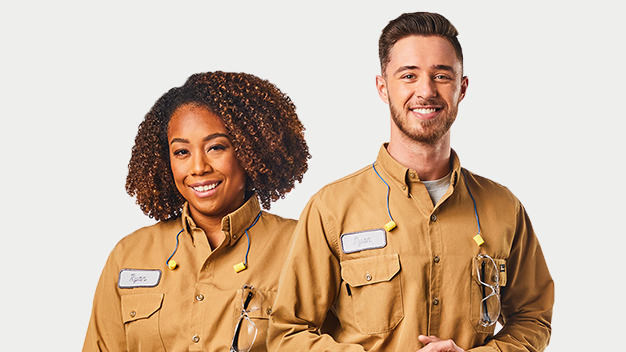 Woman and man in maintenance uniforms smiling
