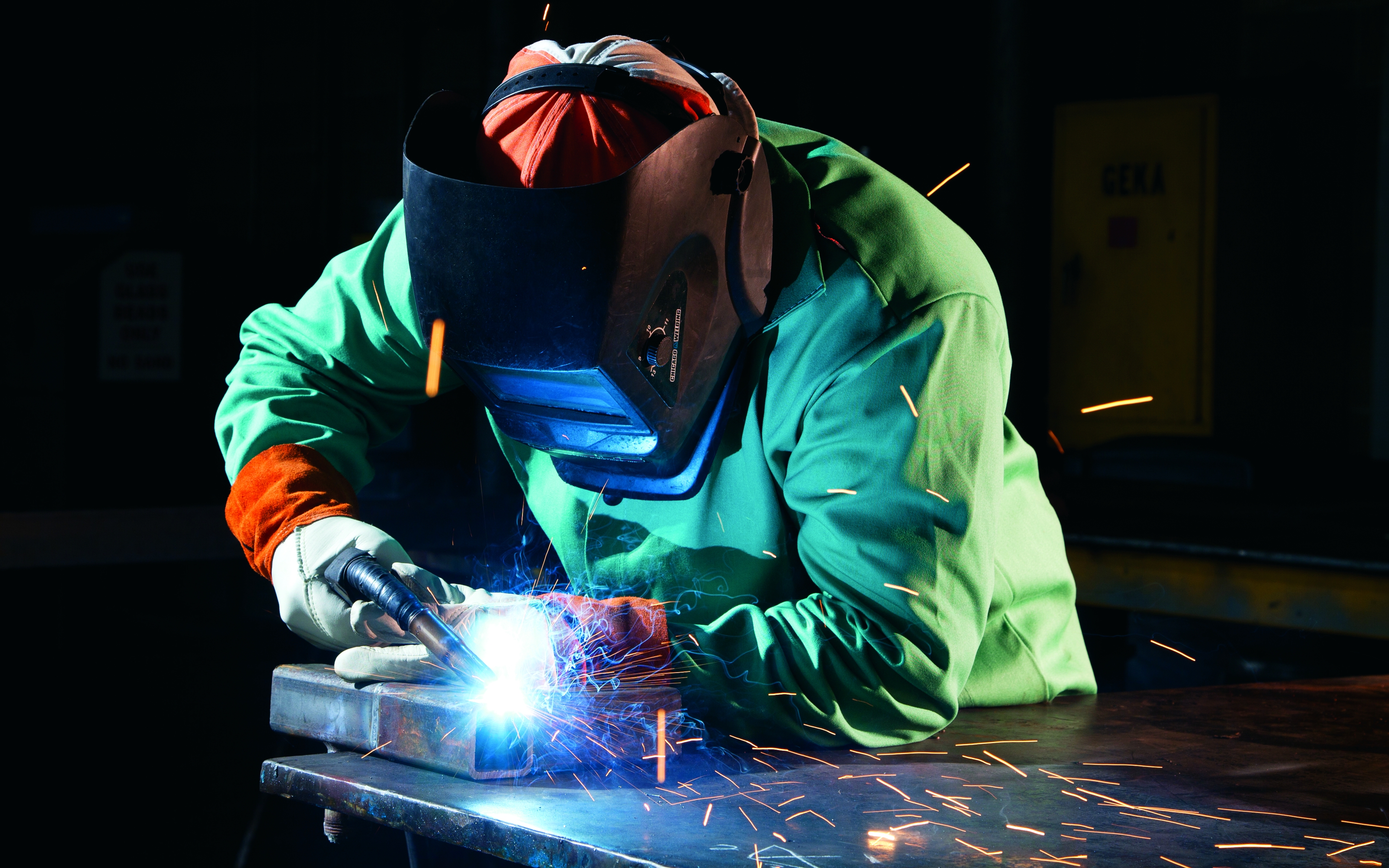 an associate welding a piece of metal