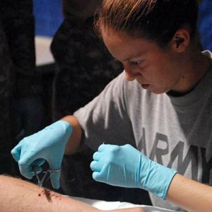 Cyndi stitching a leg