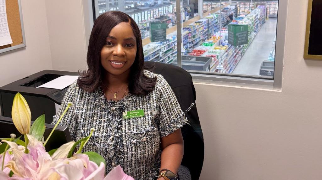 Tamara sitting at her office in a Publix store
