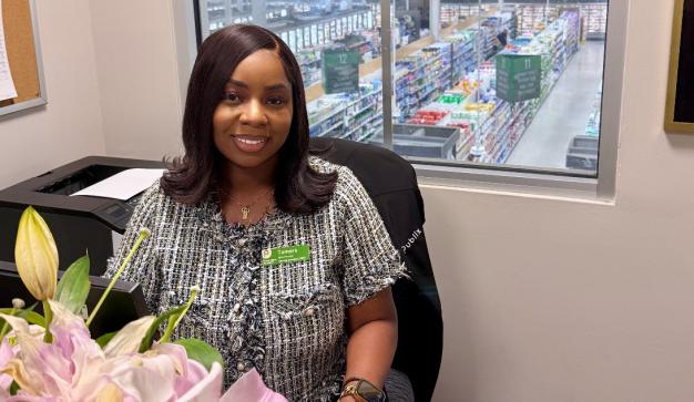 Tamara sitting at her office in a Publix store