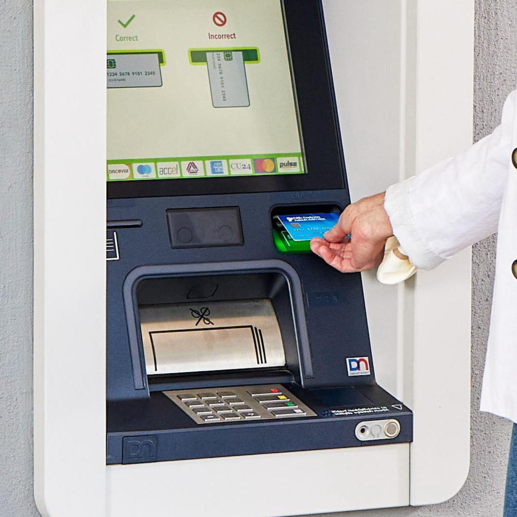 A women using a debit card at a Presto ATM