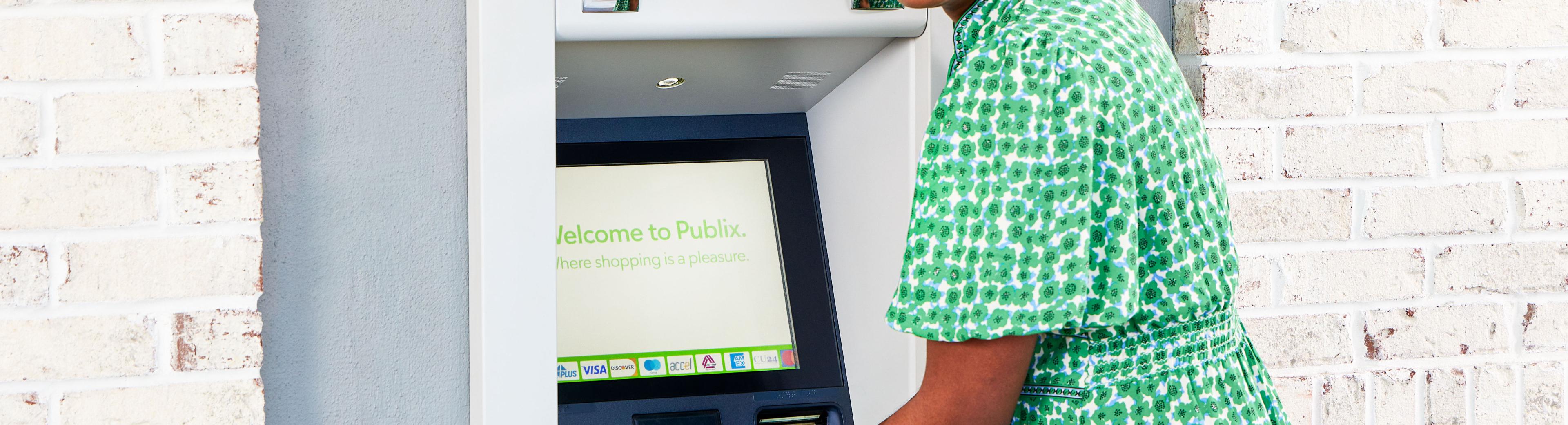 Women getting cash out of a Presto ATM