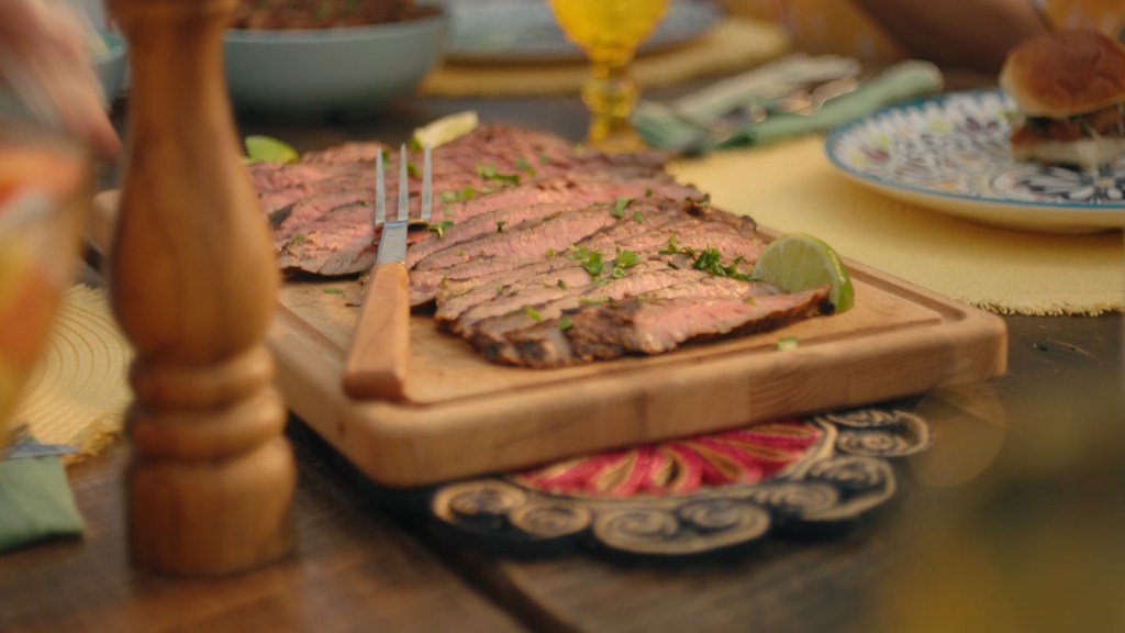 Carne asada steak on a serving board.