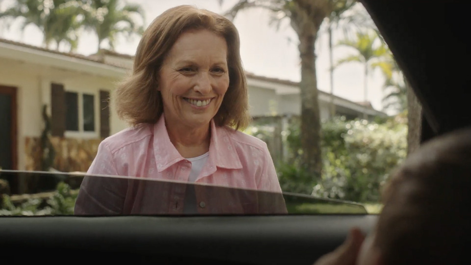 women smiling outside an open car window