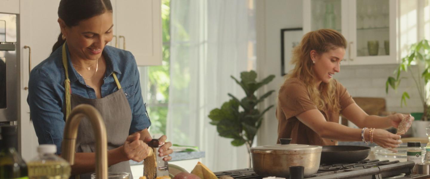 Mother and daughter cooking together