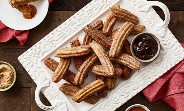 cinnamon sugar churros on a platter