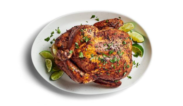 Whole roasted chicken with lime and cilantro on plate