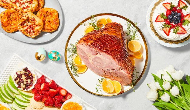 Easter table with ham, cake, and fresh fruit