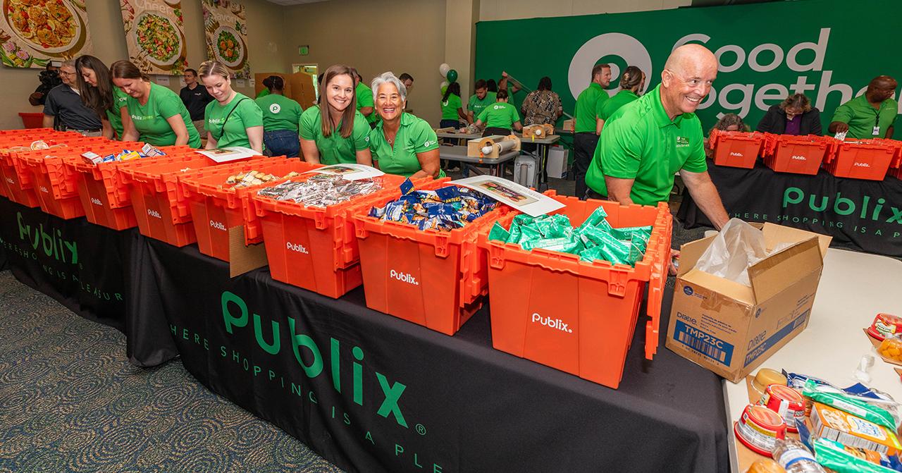 Asociados de Publix llenando cajas en un banco de alimentos