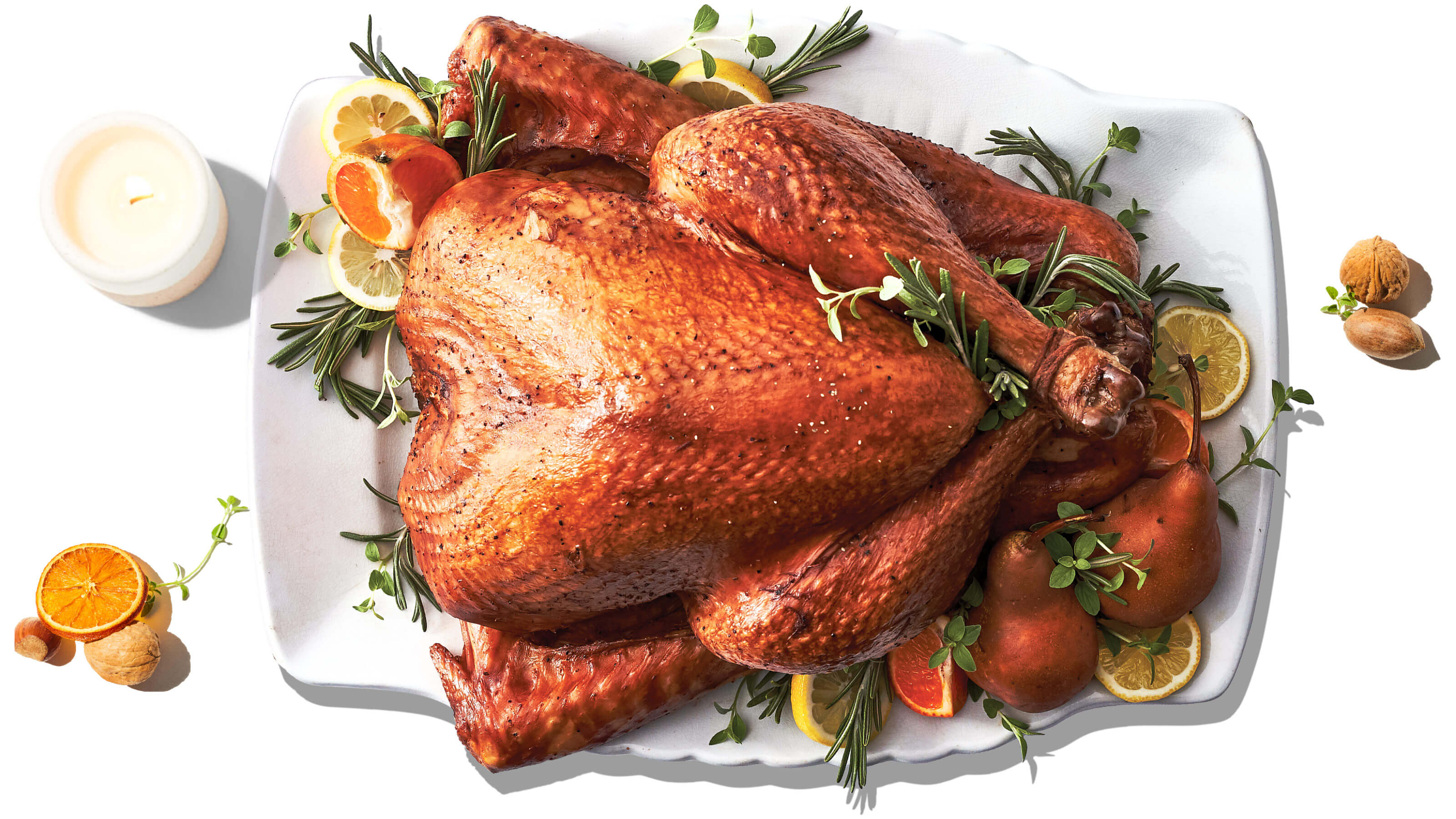 Fresh whole turkey on white background with herbs. Thanksgiving
